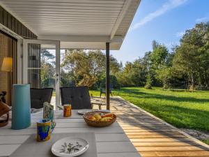 a patio with a table with a bowl of fruit at Holiday Home Tameran - 1km from the sea by Interhome in Gedesby