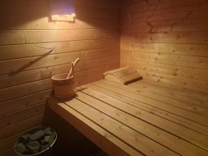 a wooden sauna with a bucket on a wooden floor at Villa Villa Rose by Interhome in Nachdemsee
