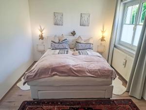 a bedroom with a white bed with blue pillows at Villa Villa Rose by Interhome in Nachdemsee