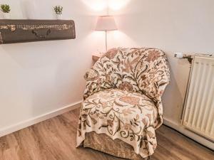 a chair in a room with a lamp at Villa Villa Rose by Interhome in Nachdemsee +54 photos