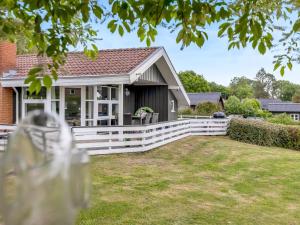a white fence in front of a house at Holiday Home Joonatan - 900m from the sea by Interhome in Hejls