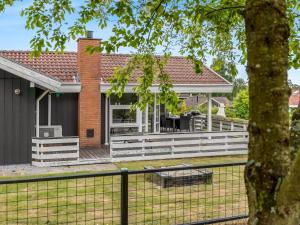 a house with a white deck and a fence at Holiday Home Joonatan - 900m from the sea by Interhome in Hejls