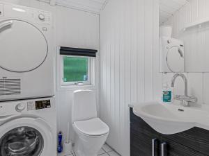 a bathroom with a washing machine and a sink at Holiday Home Joonatan - 900m from the sea by Interhome in Hejls +17 photos