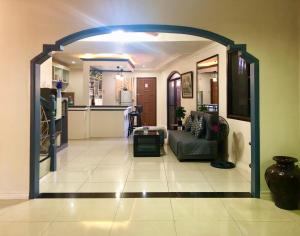 a living room with an archway leading to a kitchen at Prime Location, Spacious & Modern 4BR City Townhouse in Cagayan de Oro