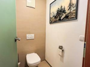 a bathroom with a toilet and a painting on the wall at Apartment Cheeky Apartment-4 by Interhome in Oberndorf in Tirol