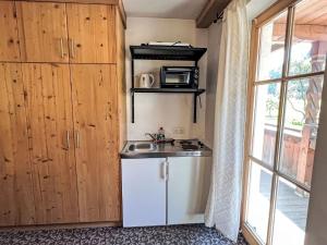 a small kitchen with a sink and a microwave at Apartment Cheeky Apartment-4 by Interhome in Oberndorf in Tirol