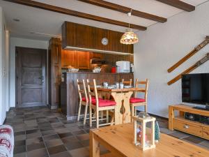 a kitchen and dining room with a table and chairs at Apartment Centaure B 103 by Interhome in Ovronnaz