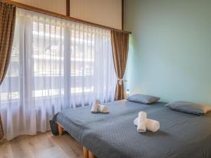 a bedroom with a bed with two towels on it at Apartment Centaure B CO 1 by Interhome in Ovronnaz