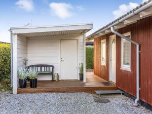 a wooden deck with a bench on a house at Holiday Home Ali - 500m from the sea by Interhome in Hejlsminde