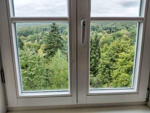 an open window with a view of a forest at Apartment Schwalenberger Land by Interhome in Schieder-Schwalenberg