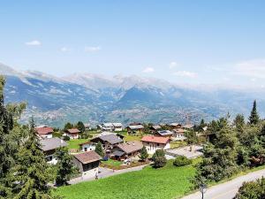 a village on a hill with mountains in the background at Apartment Bietschorn 33 by Interhome in Nendaz