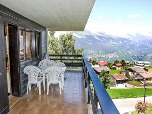 a balcony with a table and chairs and a view at Apartment Bietschorn 33 by Interhome in Nendaz