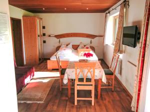 a bedroom with a table and a bed in a room at Apartment Studio Grenta by Interhome in Gortipohl +2 photos