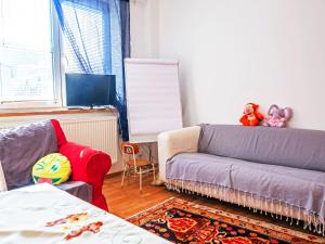 a living room with a couch and a chair at Apartment ProFamily by Interhome in Jáchymov +15 photos