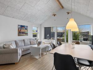 a living room with a couch and a table at Holiday Home Lanica - 150m from the sea by Interhome in Dalby