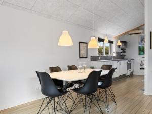 a dining room and kitchen with a table and chairs at Holiday Home Lanica - 150m from the sea by Interhome in Dalby