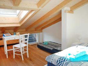 a bedroom with a bed and a desk and a chair at Apartment Cà dal Non by Interhome in Ronco s/Ascona - Porto Ronco