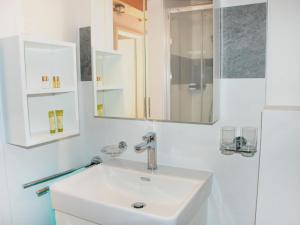 a white bathroom with a sink and a mirror at Apartment Cà dal Non by Interhome in Ronco s/Ascona - Porto Ronco