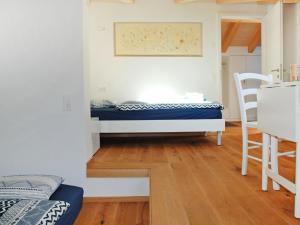 a small room with a bed and a table at Apartment Cà dal Non by Interhome in Ronco s/Ascona - Porto Ronco +21 photos