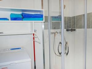 a bathroom with a shower and a washer and dryer at Apartment Cà dal Non by Interhome in Ronco s/Ascona - Porto Ronco