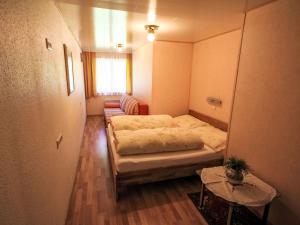 a small room with two beds and a table at Apartment Apartment Kriasi by Interhome in Gortipohl
