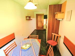 a room with a table and chairs and a room with a hallway at Apartment Apartment Kriasi by Interhome in Gortipohl