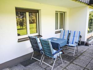 a blue table and chairs sitting on a patio at Apartment Apartment Kriasi by Interhome in Gortipohl