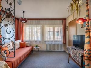 a living room with a couch and a tv at Holiday Home Elisabeth by Interhome in Mallnitz