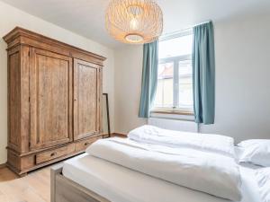 a bedroom with two beds and a wooden cabinet at Holiday Home Lili's with terrace by Interhome in Blankenberge