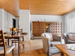a living room with a table and chairs at Apartment Castor und Pollux-6 by Interhome in Täsch +26 photos