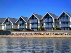 a row of houses next to the water at Ten Admiralty Pier in Shotley Gate