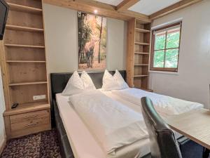 a bedroom with a bed and a desk and a window at Apartment Cheeky Apartment-3 by Interhome in Oberndorf in Tirol