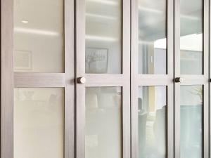 a pair of glass doors in a room at Apartment Lakeview App 501 by Interhome in Moscia