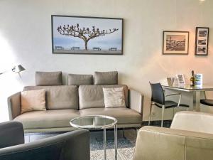 a living room with a couch and a table at Apartment Lakeview App 501 by Interhome in Moscia