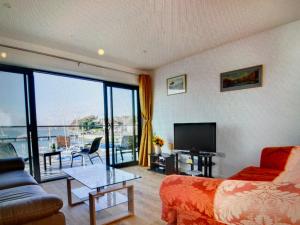 a living room with a couch and a television at Ten Admiralty Pier in Shotley Gate