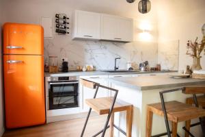 a kitchen with an orange refrigerator and a counter at Ca' Dij Noni in Strona