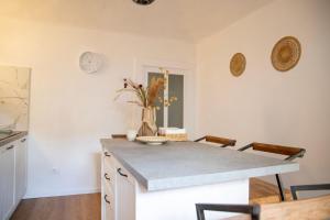 a kitchen with a counter and a table with chairs at Ca' Dij Noni in Strona +32 photos