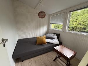 a small living room with a couch and a table at Holiday Home Gun - 300m to the fjord by Interhome in Glostrup