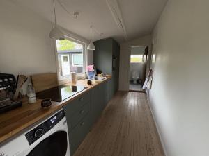 a kitchen with a sink and a dishwasher at Holiday Home Gun - 300m to the fjord by Interhome in Glostrup