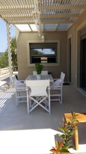 a white table and chairs on a patio at Villa Lilium in Athanion