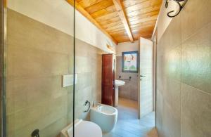 a bathroom with a toilet and a sink at ISA - Lofts with private outdoor area and swimming-pool in Badesi in Badesi