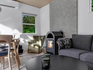 a living room with a fireplace and a table at Holiday Home Cornel - 300m from the sea by Interhome in Strøby Ladeplads