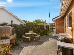 a patio with a picnic table and a grill at Holiday Home Wraghi - 21km from the sea by Interhome in Højer