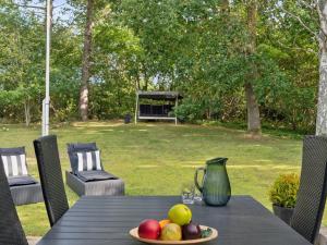 a table with a plate of fruit on top of it at Holiday Home Baarde - 1-2km from the sea by Interhome in Vejby +18 photos
