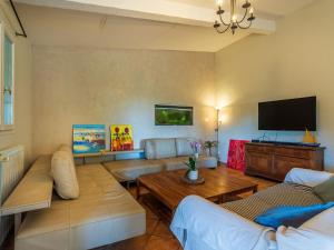 a living room with couches and a flat screen tv at Villa Palmeraie by Interhome in Hyères +26 photos