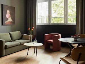 a living room with a couch and a table at Numa Berlin Sketch in Berlin +27 photos