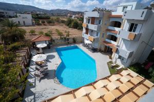an overhead view of a swimming pool next to a building at Dimitra Hotel & Apartments by Omilos Hotels in Kokkini Khanion +47 photos