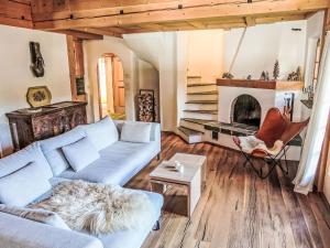 a living room with a couch and a fireplace at Chalet Spunda Biala by Interhome in Laax