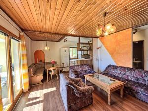 a living room with couches and a table at Apartment Hochstuhlblick by Interhome in Pugrad