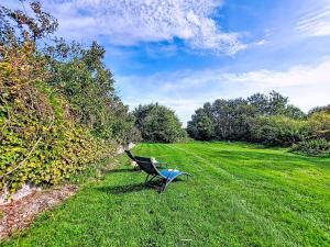 a bench sitting in the grass in a field at Holiday Home De cap en cap by Interhome in Trouguennour +31 photos